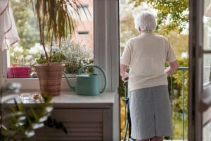 Old lady at standing at a doorway