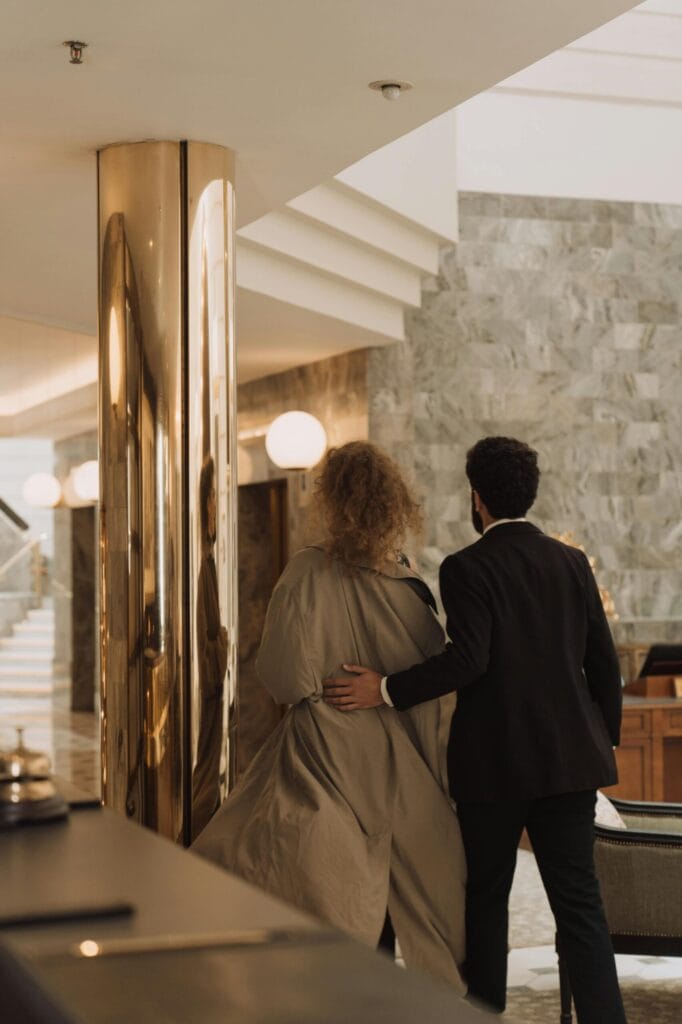 A couple walking in a luxurious hotel lobby